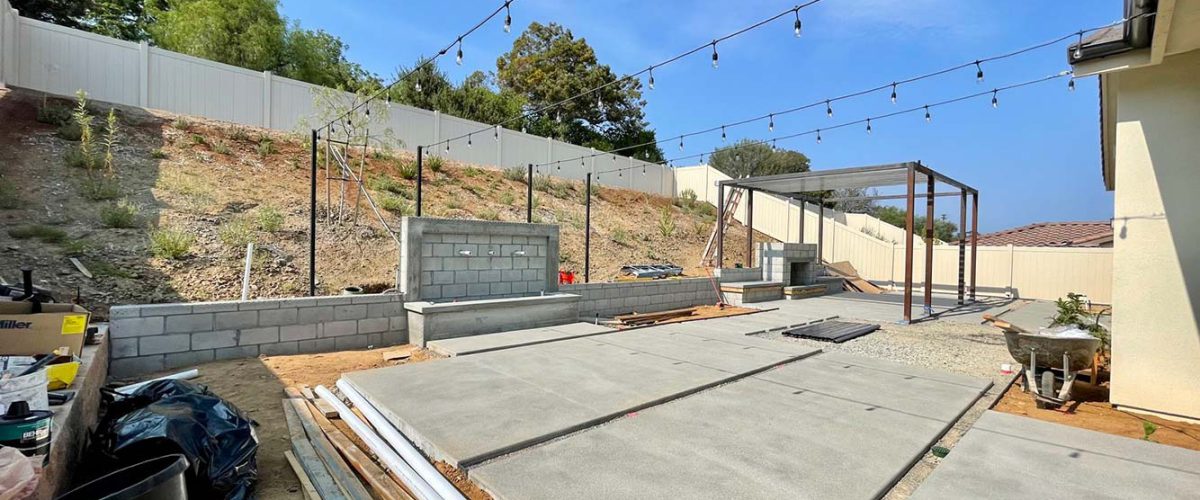 backyard-design-in-progress-with-cement-market-lights-fountain-and-gazebo_t20_A33OVP